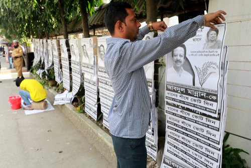 Dhaka, Bangladesh-December 23, 2018: A Bangladeshi people assists as others prepare election campaign material in Dhaka. Parliament election is scheduled to be held in Bangladesh on December 30, 2018.