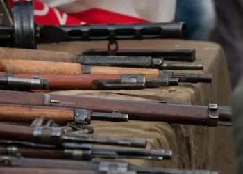 weapons laid out on the table Arms trafficking. different rifles on the counter in the gun shop. clandestine sale of weapons. illegal purchase of weapons. firearms on the table. illegal deal to sell w