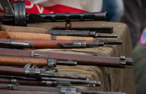 weapons laid out on the table Arms trafficking. different rifles on the counter in the gun shop. clandestine sale of weapons. illegal purchase of weapons. firearms on the table. illegal deal to sell w