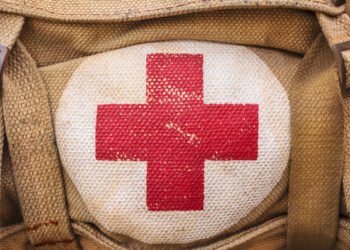 medical aid symbol on a vintage jute army bag