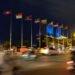 Ho Chi Minh, Vietnam - April 6, 2019: Multinational flags in ASEAN community country in the night time at Saigon with people, cars and motorcycles on the road.