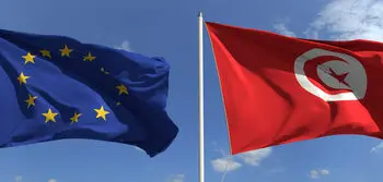 Flying,Flags,Of,The,European,Union,And,Tunisia,On,Sky