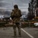 Irpin, Ukraine - 5 March 2022: Ukrainian soldier stands on the check point to the city Irpin near Kyiv during the evacuation of local people under the shelling of the Russian troops.