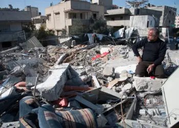 GAZA, PALESTINIAN TERRITORY - DECEMBER 3: A man combs amid the rubble of the Palestinian National Authority Council of Ministers building, December 3, 2012.