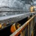 Belt conveyor in an underground tunnel. Transportation of ore to the surface