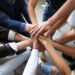 Top,Close,Up,Lot,Of,Hands,Stacked,Together,As,Symbol