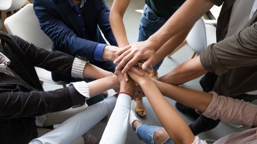 Top,Close,Up,Lot,Of,Hands,Stacked,Together,As,Symbol