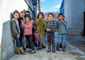 Velykyi Bereznyi, Ukraine - February 28, 2021: Group of cute gypsy kids in ghetto. Ukrainian Roma children in Carpathian mountains.