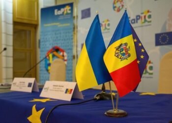 Chisinau, Moldova - 02 01 2017: on the table are three flags - Ukraine, the Republic of Moldova and the EU against the background of banners in the hall for meetings of official delegations