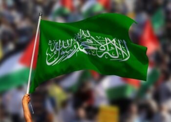 A man holding a Hamas flag waving on Palestinian solidarity rallies around the world in support of Palestine