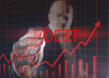 Debt growth graph on a virtual screen. Financier draws a rating for debt obligations. Concept - growth of public debt. Ìan with a stylus in background. Economy. Financial market. Credit liabilities
