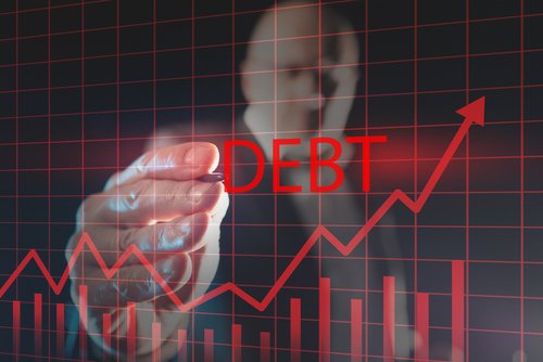 Debt growth graph on a virtual screen. Financier draws a rating for debt obligations. Concept - growth of public debt. Ìan with a stylus in background. Economy. Financial market. Credit liabilities