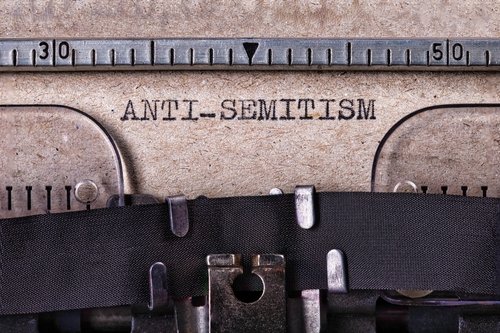 The inscription "Antisemitism" written on a gray sheet with a typewriter font.