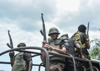 Armed police officers guarding outside the High Court in Dar es Salaam, Tanzania on October 20, 2021