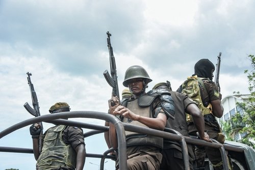 Armed police officers guarding outside the High Court in Dar es Salaam, Tanzania on October 20, 2021