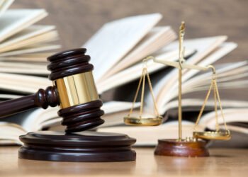 wooden gavel and books on wooden table