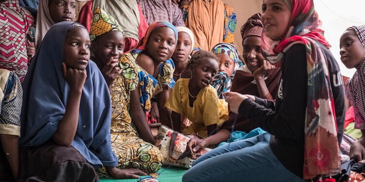 (right) Syrian refugee and education activist Muzoon Almellehan meets Nigeria refugee girls at a sewing workshop in Daresalam refugee camp, Lake Region, Chad, Thursday 20 April 2017.

More than 25 million children between 6 and 15 years old, or 22 per cent of children in that age group, are missing out on school in conflict zones across 22 countries. In response to the education crisis in Chad, UNICEF has since the start of 2017 provided school supplies to more than 58,000 students, distributed teaching materials to more than 760 teachers, and built 151 classrooms, 101 temporary learning spaces, 52 latrines and 7 sports fields. UNICEF Chad also supported the salaries of 327 teachers for the 2016-2017 school year.

To help drive an increased understanding of the challenges children affected and uprooted by conflict face in accessing school, UNICEF advocate Muzoon Almellehan, a 19-year-old Syrian refugee and education activist, travelled to Chad, a country where nearly three times as many girls as boys of primary-age in conflict areas are missing out on education.