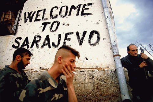 Soldiers and Paramilitaries - Bosnian soldiers smoke and take a break on the frontline next to a sign that says 'welcome to Sarajevo' in Sarajevo, Bosnia, in the fall of 1994.  Trench warfare was fought all around the city of Sarajevo.