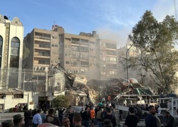 Emergency and security personnel gather at the site of strikes which hit a building adjacent to the Iranian embassy in Syria's cpital Damascus, on April 1, 2024. Israeli strikes hit Syria's capital on April 1, state media reported, as a war monitor said six people were killed in a building adjacent to the Iranian embassy. (Photo by Maher AL MOUNES / AFP)