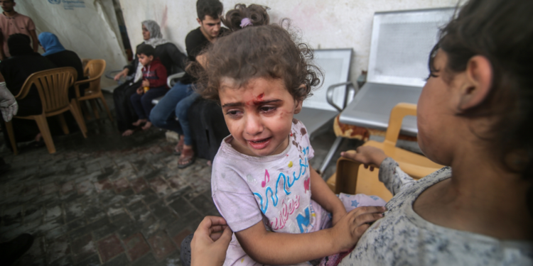 Palestinians evacuate wounded after an Israeli airstrike in Rafah refugee camp, southern Gaza Strip,